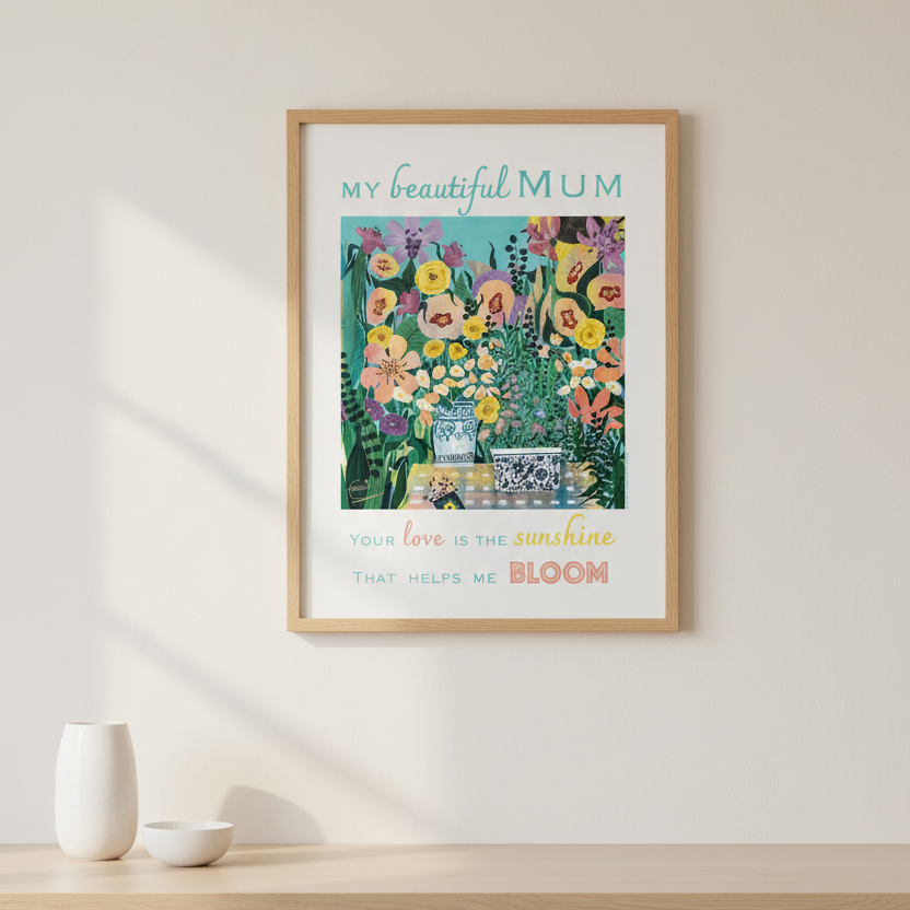 A framed floral art print with the text 'MY beautiful MUM' and 'YOUR LOVE IS THE sunshine THAT HELPS ME BLOOM' hangs on a light beige wall above a wooden sideboard with white ceramic vases.