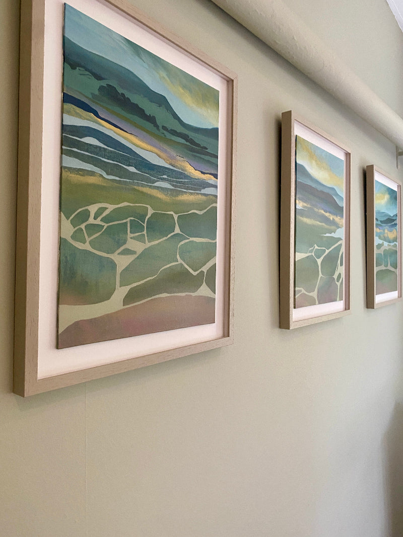 Three framed abstract artworks on a wall