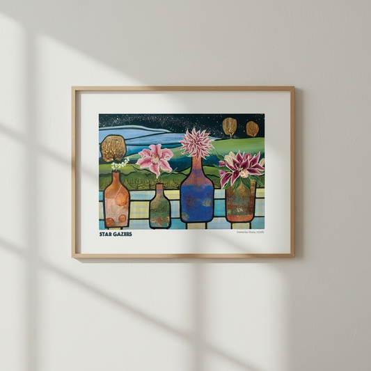 A framed art print titled '4 PM GAMES' hangs on a light beige wall, casting soft window-shadow lines. The print features a colorful, stylized illustration of four flower-filled glass bottles against a night sky, enclosed in a light wood frame with a white mat.