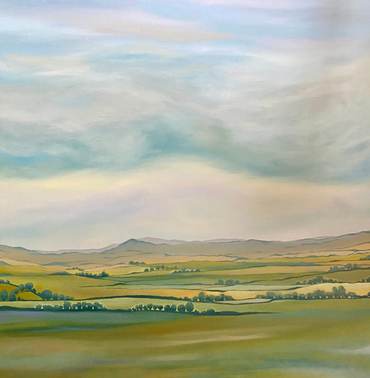 Landscape painting of rolling hills and a rainbow in the sky