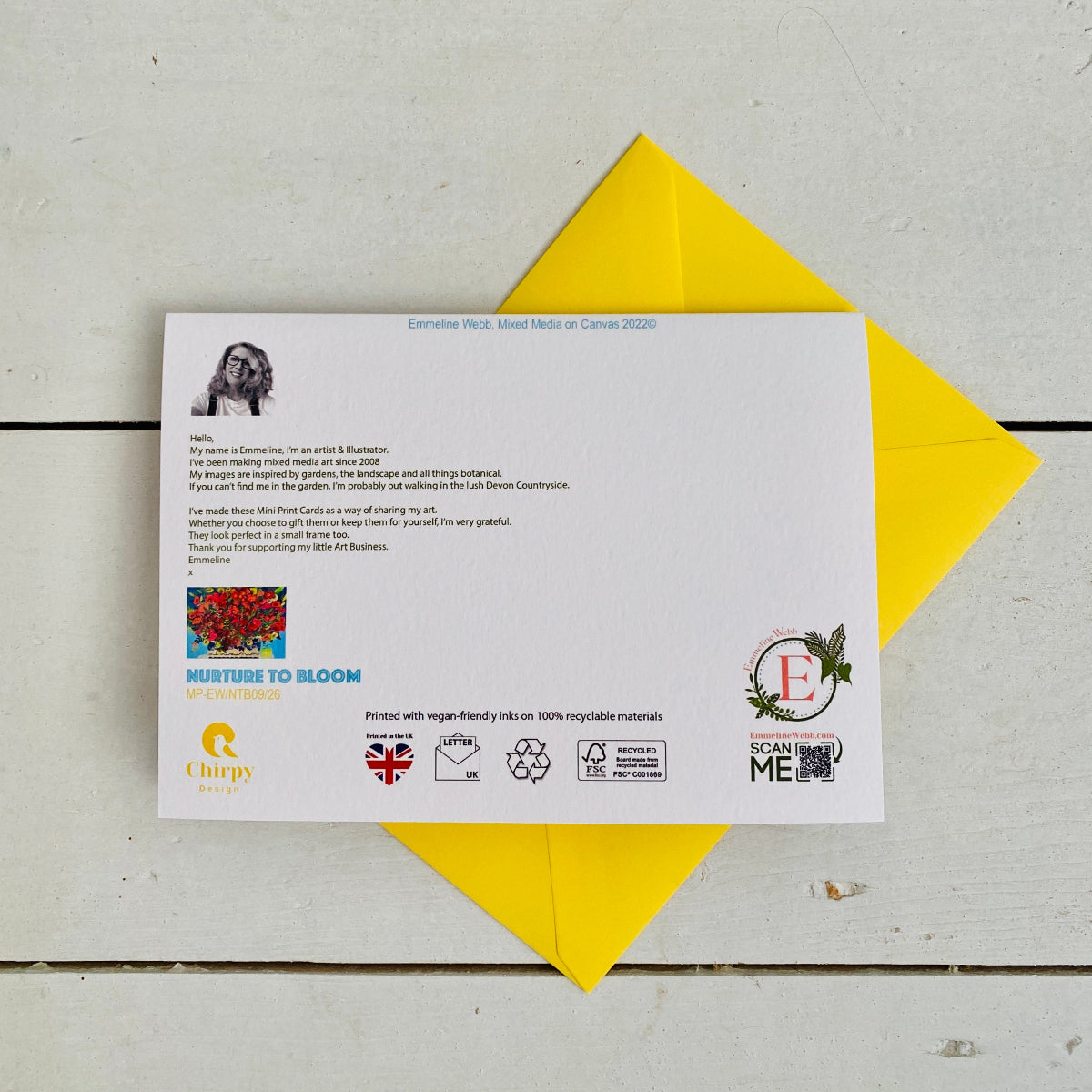 A printed card with a poem and small artwork is placed on top of a bright yellow envelope on a light wood surface. The card includes logos and text such as 'Emotional Roots: Speed Work of Canopy 2020' and 'Nurture TO BLOOM'.