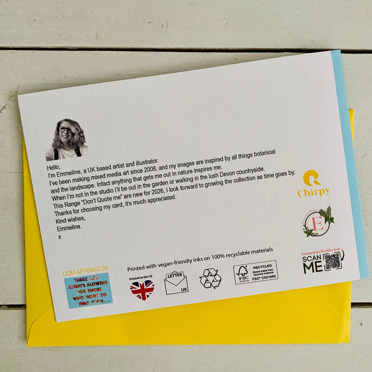 A printed card or letterhead laid on top of a yellow envelope against a light wood background. The card contains a portrait, a short letter, and several logos and icons, including Chipy and a recycling symbol.