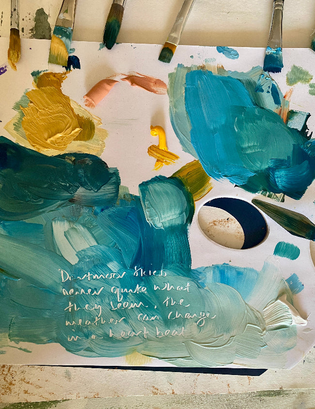 Artists palette with paint brushes, blue and green colors, accompanied by text on a white background.